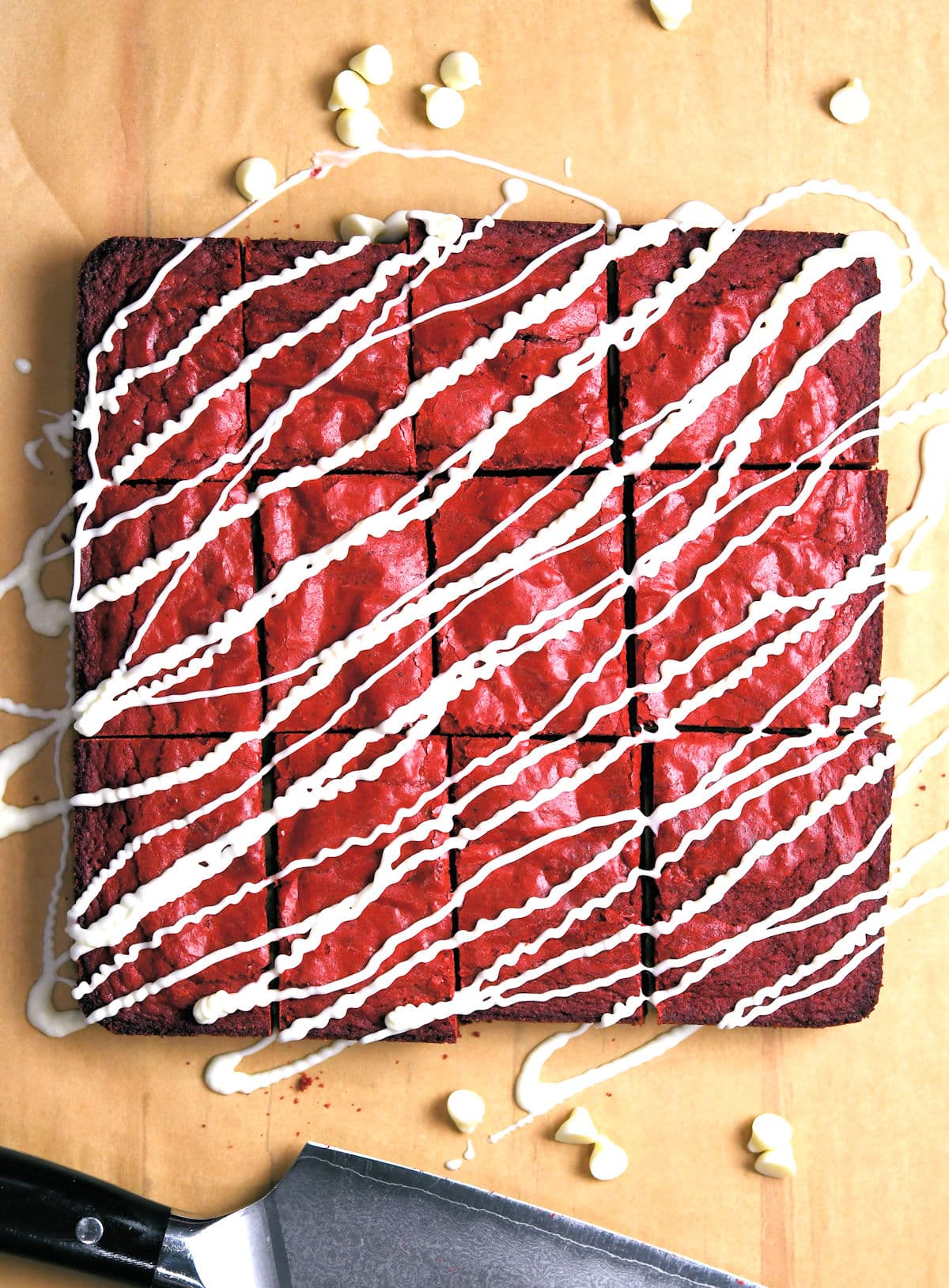 Red velvet brownies on a parchment paper, cut into 9 pieces 