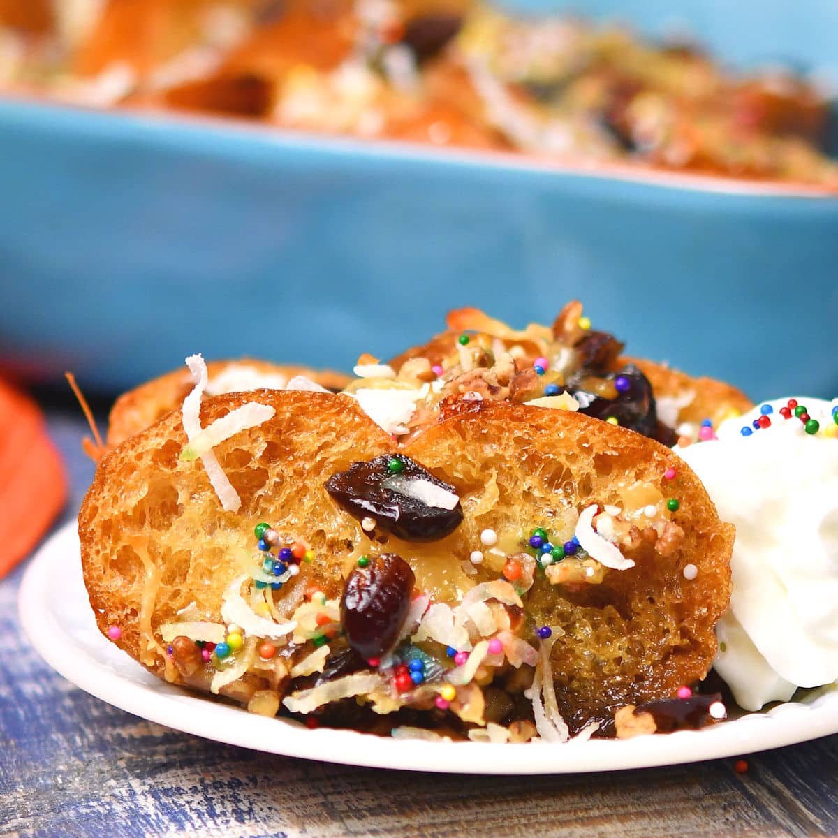 two slices of Mexican capirotada served with whipped cream