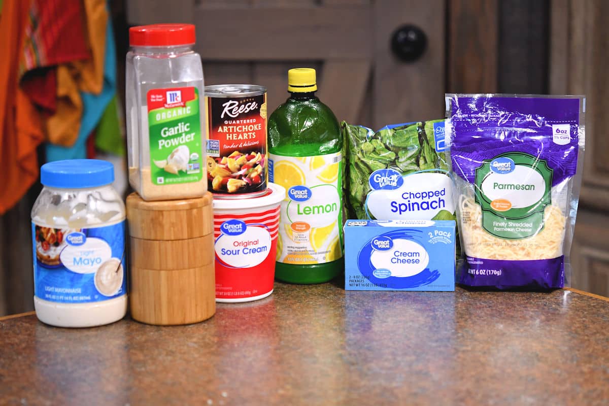 ingredients of cold spinach and artichoke dip on a countertop