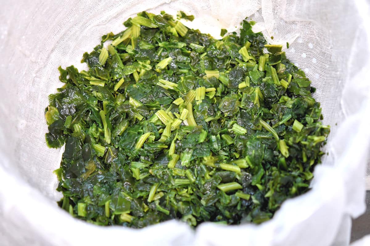 chopped spinach in a cheesecloth