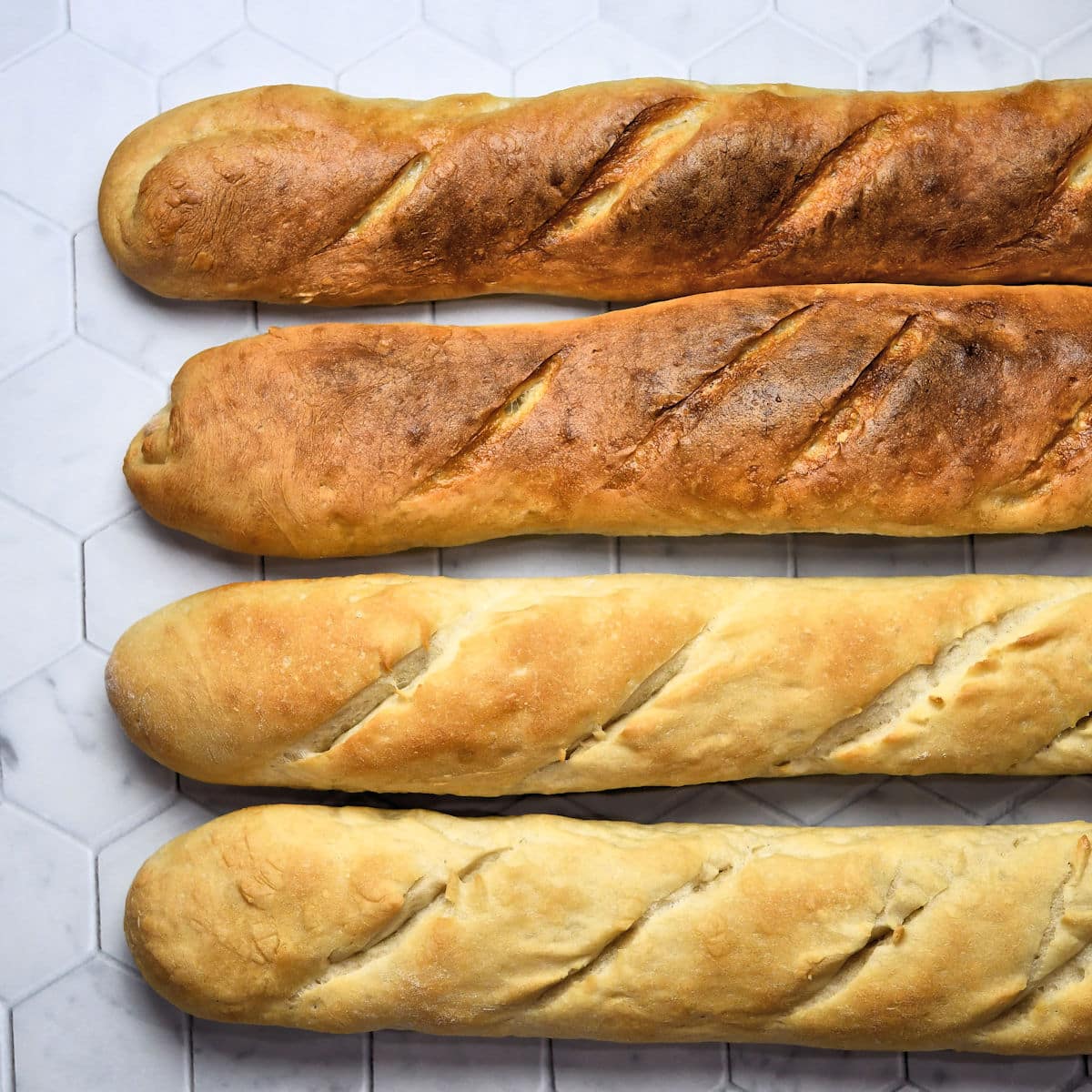 baguette loaves in different crust colors from dark to light