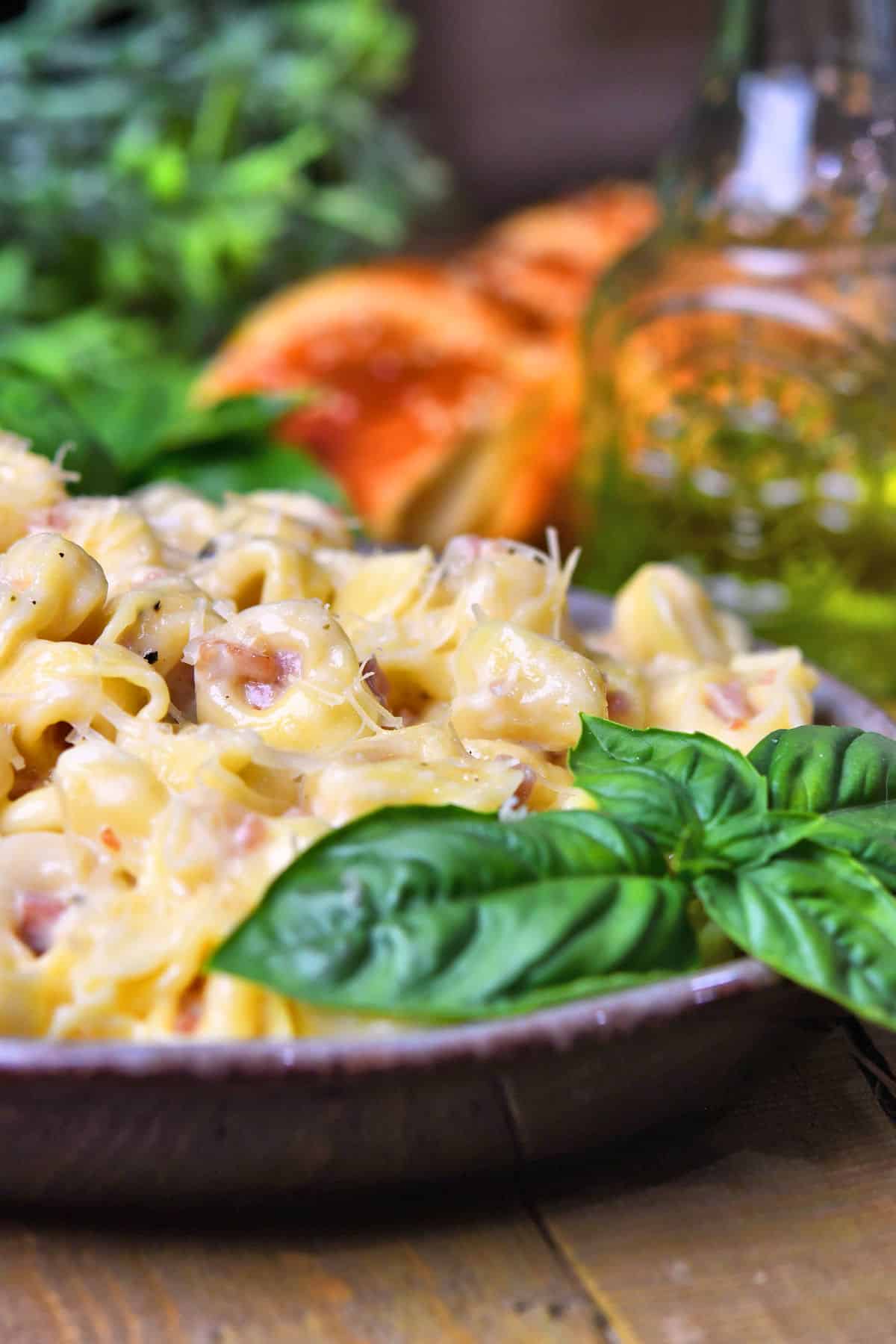 Tortellini Alla Panna on a plate on a  table with oil and bread