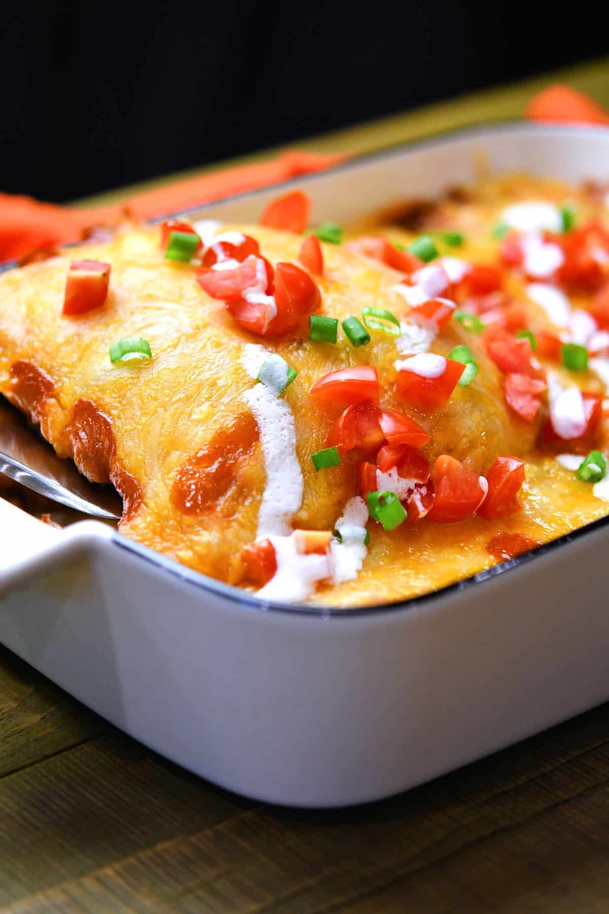 closeup of casserole dish of taquitos enchiladas