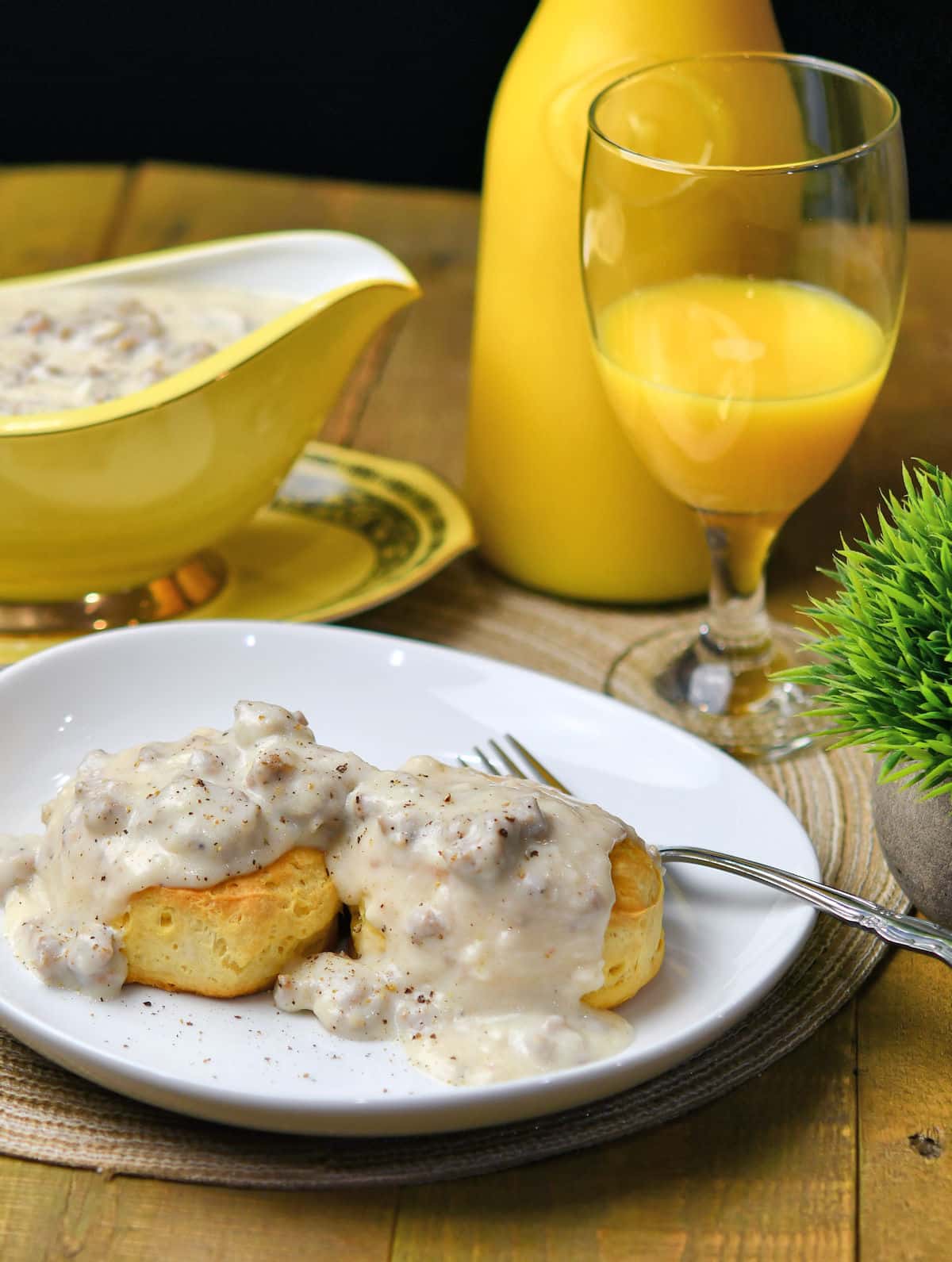 Homemade Sausage Gravy served on biscuits with glass of orange juice