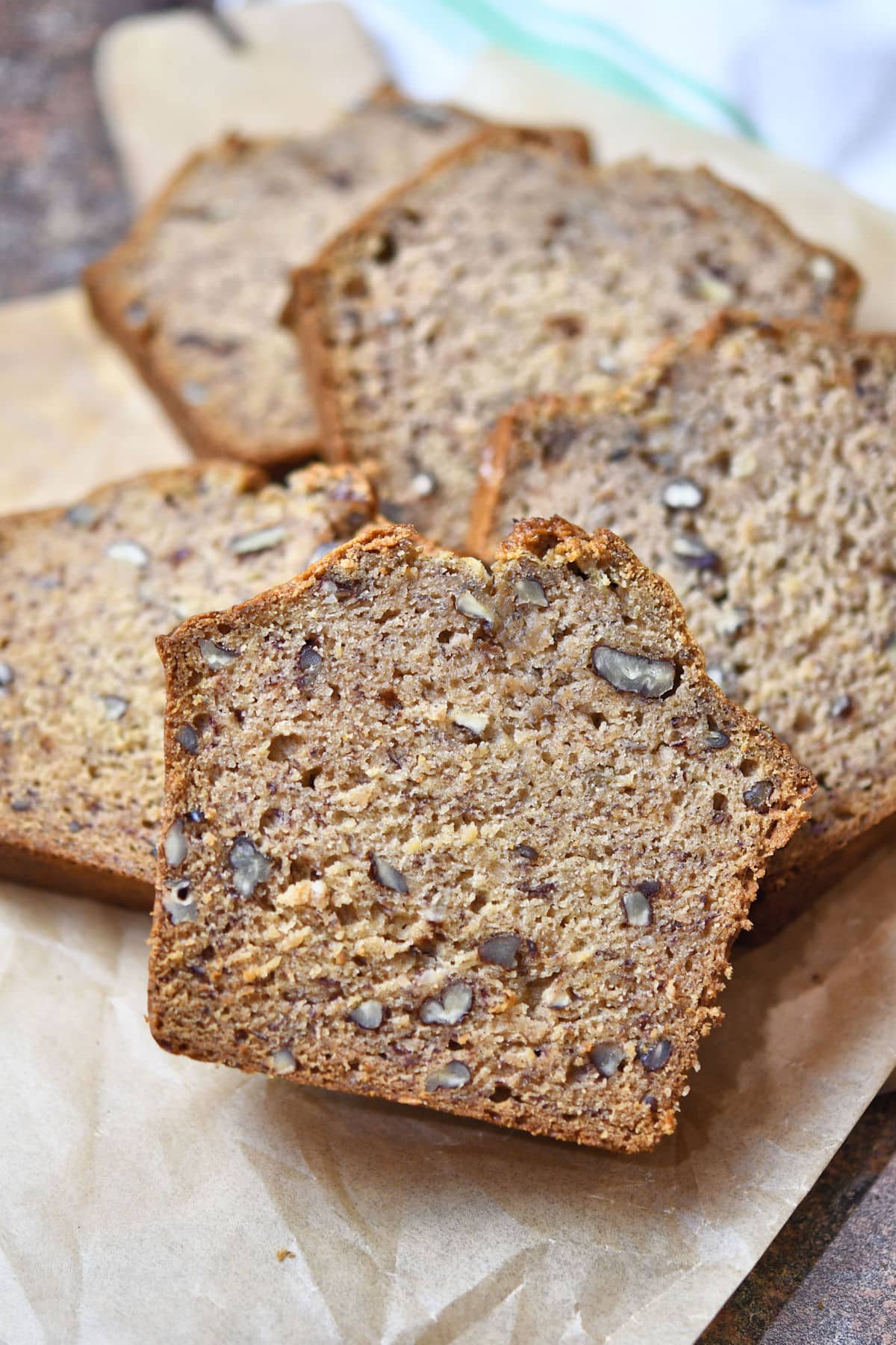 Nicely sliced dairy free banana bread with no eggs  on a parchment paper.