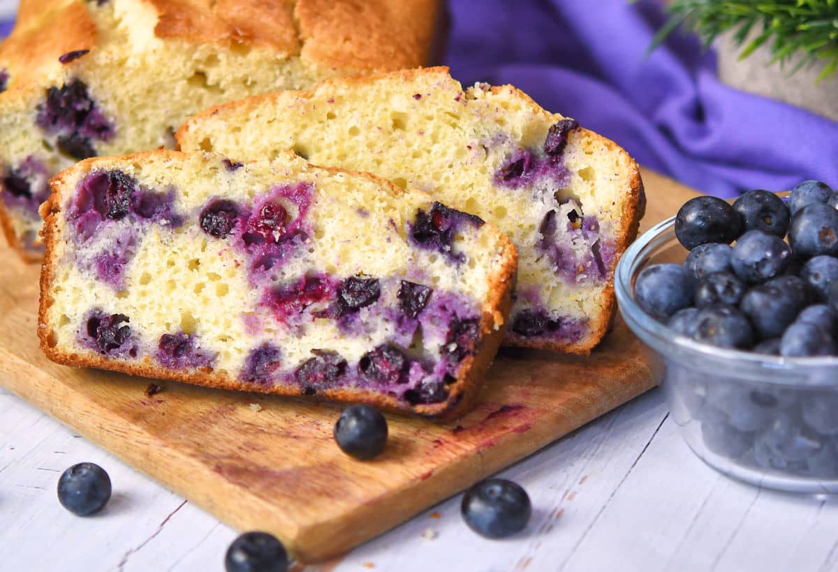 Slices of fresh blueberry loaf bread on a cutting board