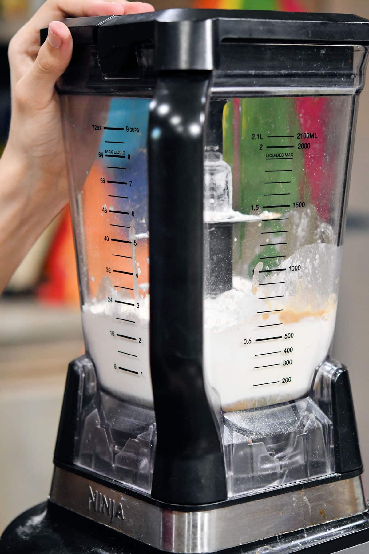 an electric blender with a milk egg mixture inside