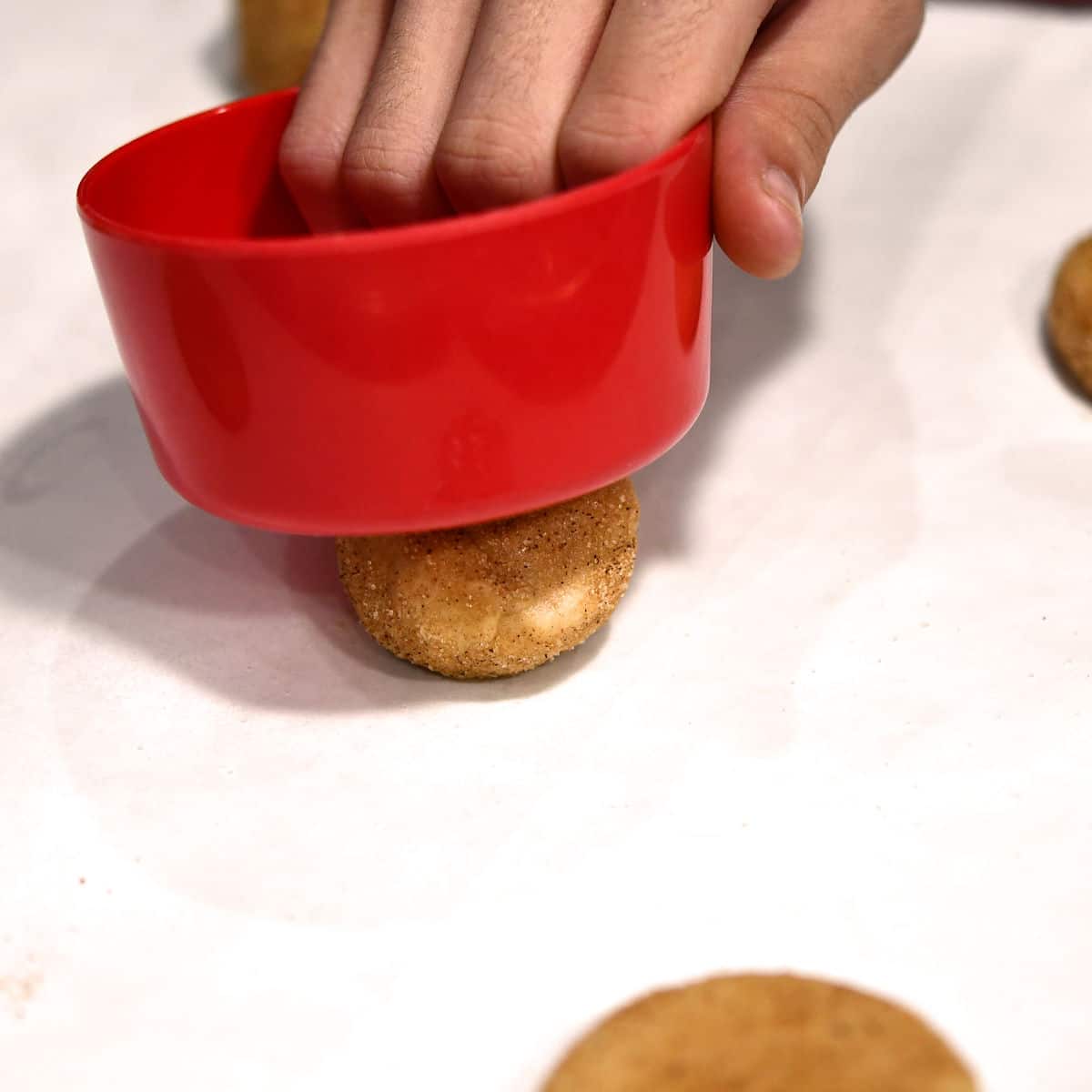 using small cup to smash cookie dough ball before baking