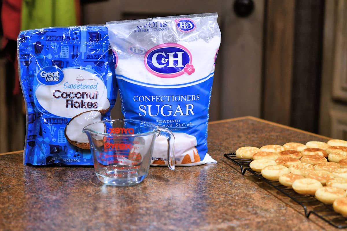 coconut flakes and powdered sugar on a countertop.