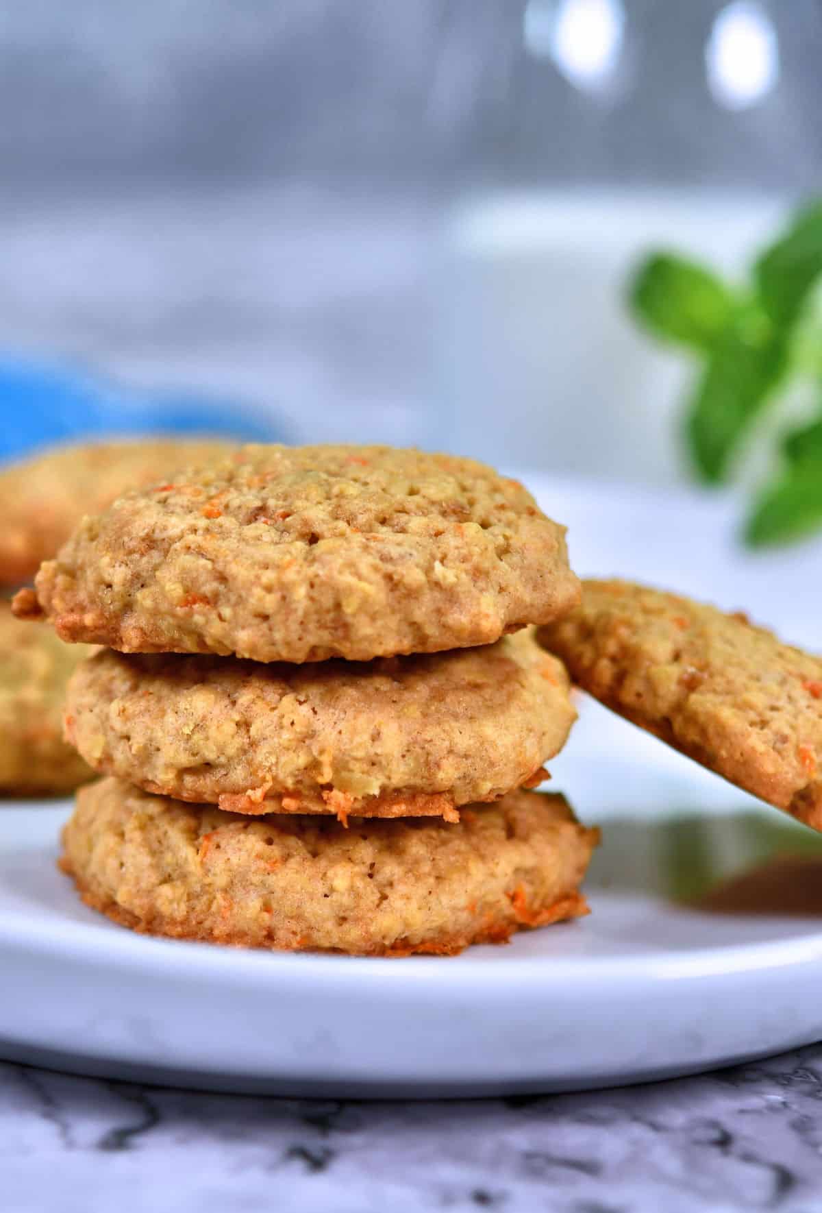 oatmeal carrot cookies stacked on white plate.
