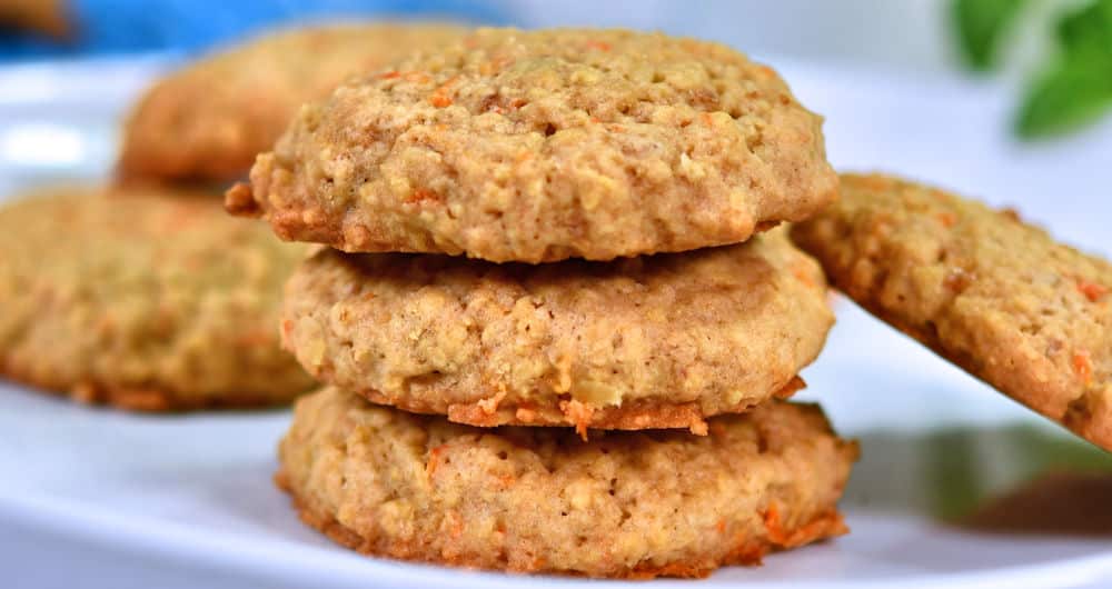 oatmeal carrot cookies stacked on white plate.