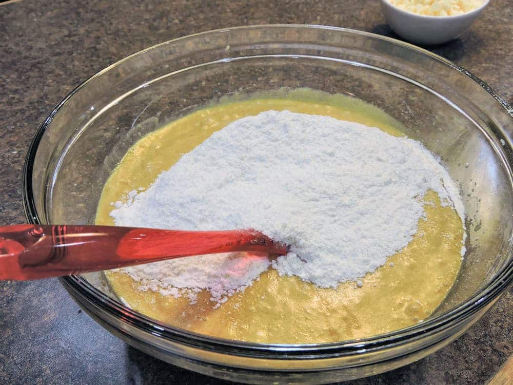 clear glass mixing bowl with batter and flour.