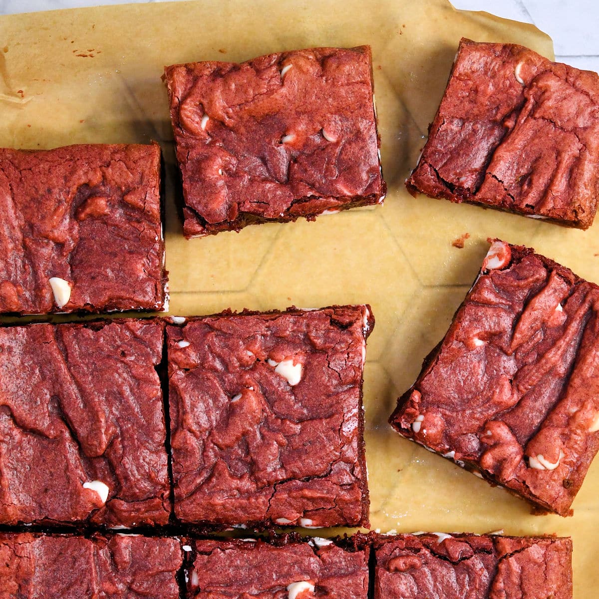Red velvet brownies on a parchment paper, cut into 9 pieces 