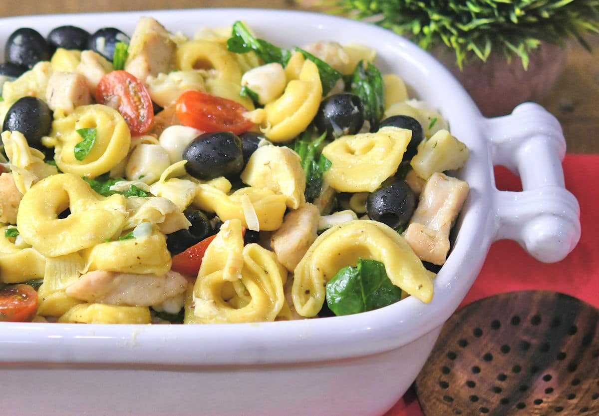 tender tortellini pasta with bites of chicken in a white ceramic bowl