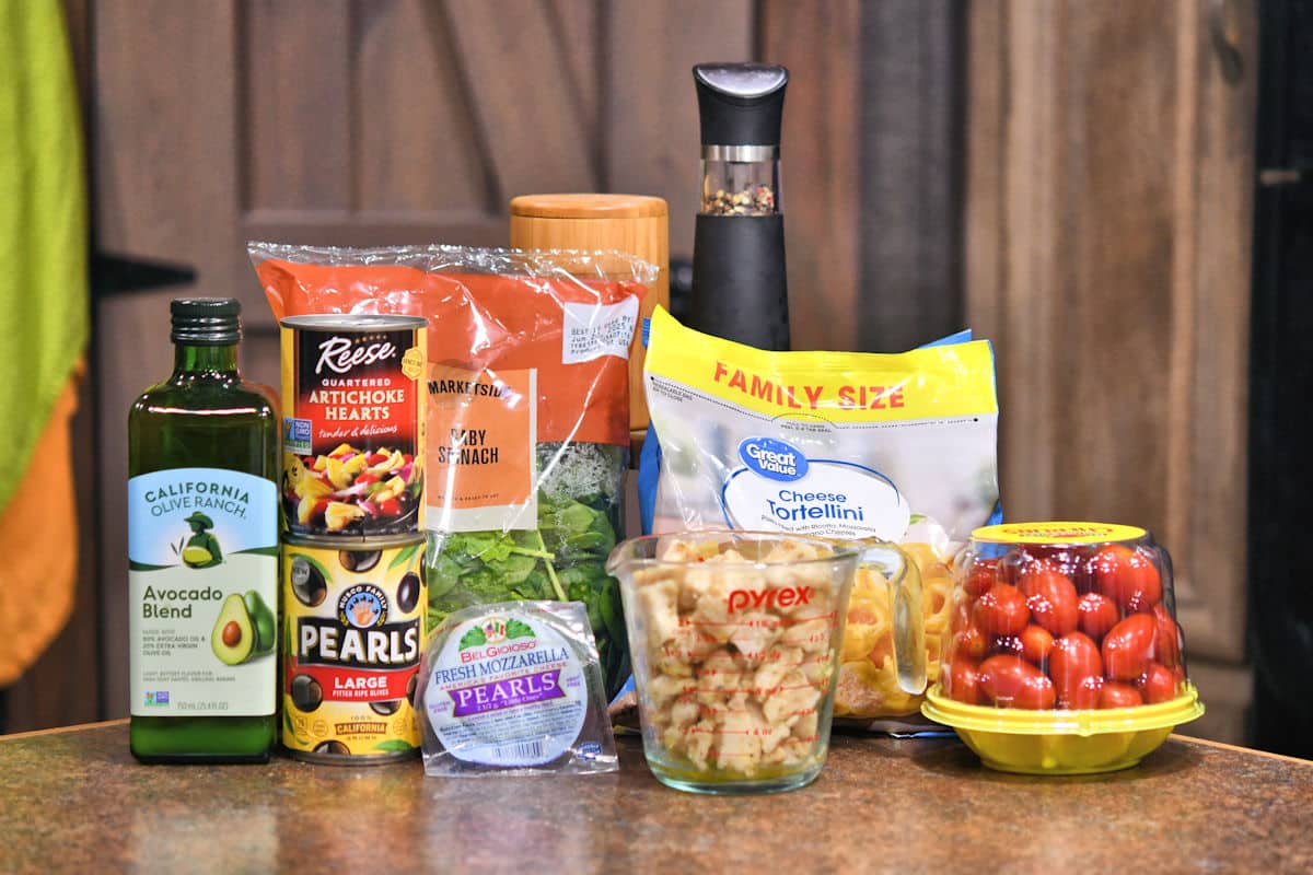 ingredients for chicken tortellini salad on a countertop