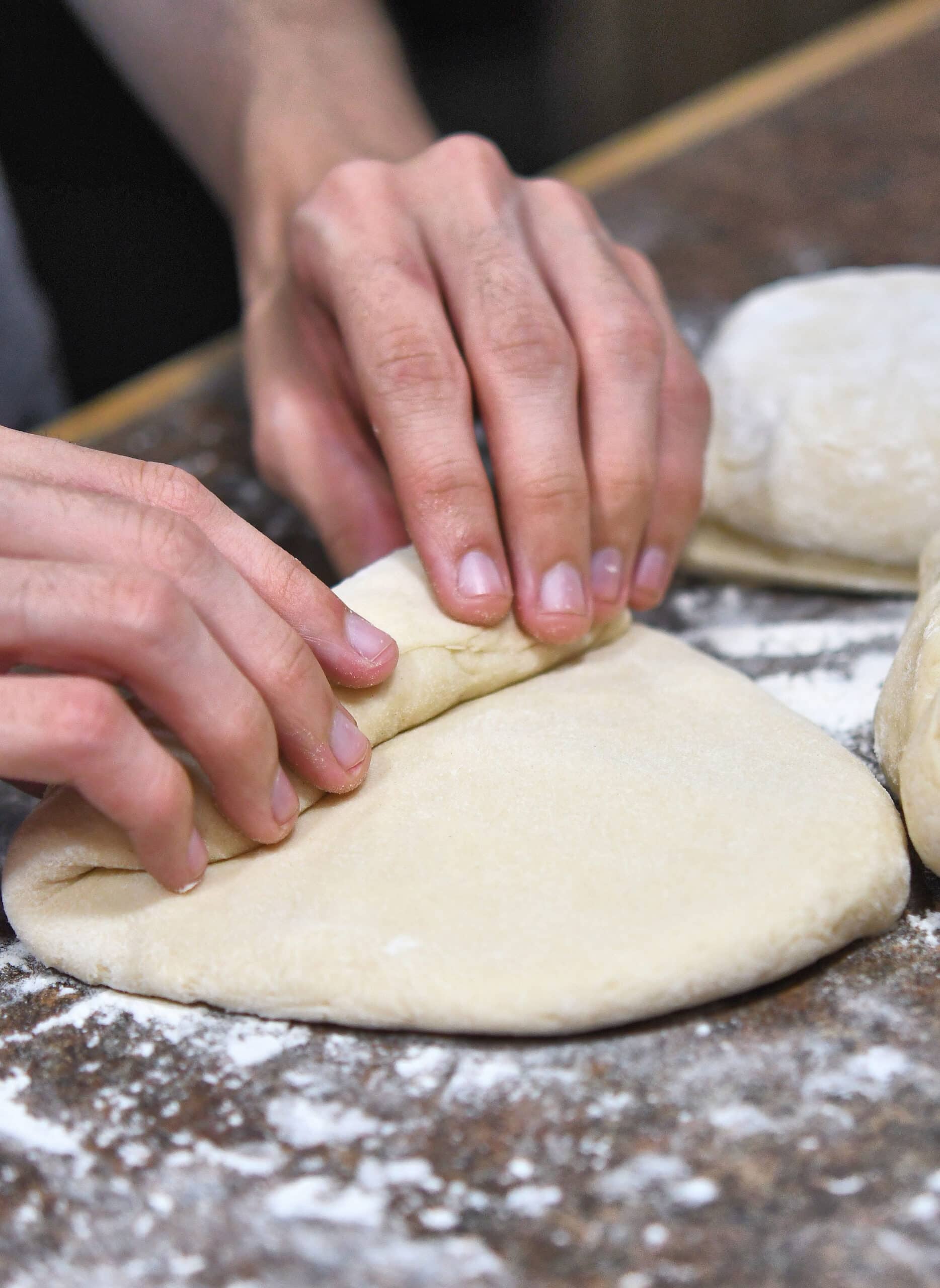 rolling up the individual pieces of bread dough for pullman pan