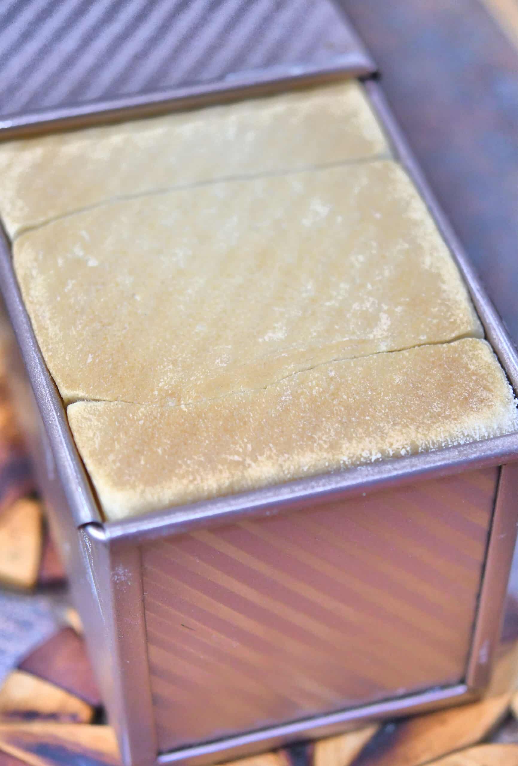 the bread rises to the very top of the pullman pan lid, filling all corners