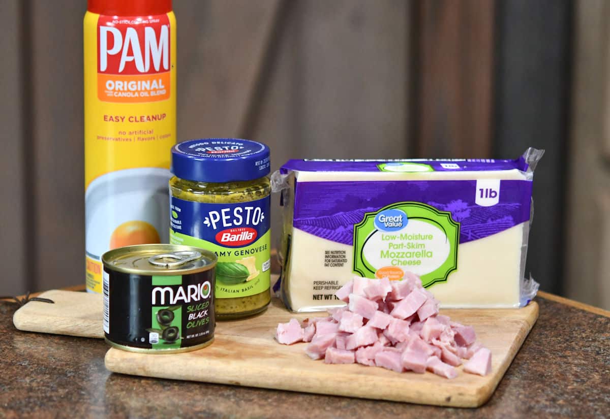ingredients for gourmet pesto pizza on a countertop