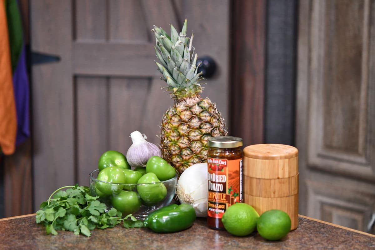 fresh ingredients for pineapple tomatillo salsa on a counter