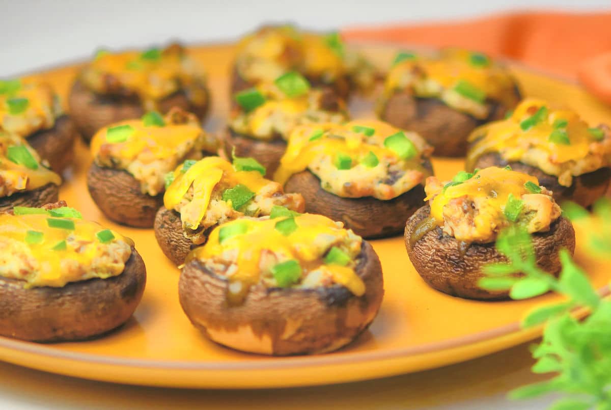 Jalapeno Popper Stuffed Mushrooms Appetizers on a yellow ceramic plate