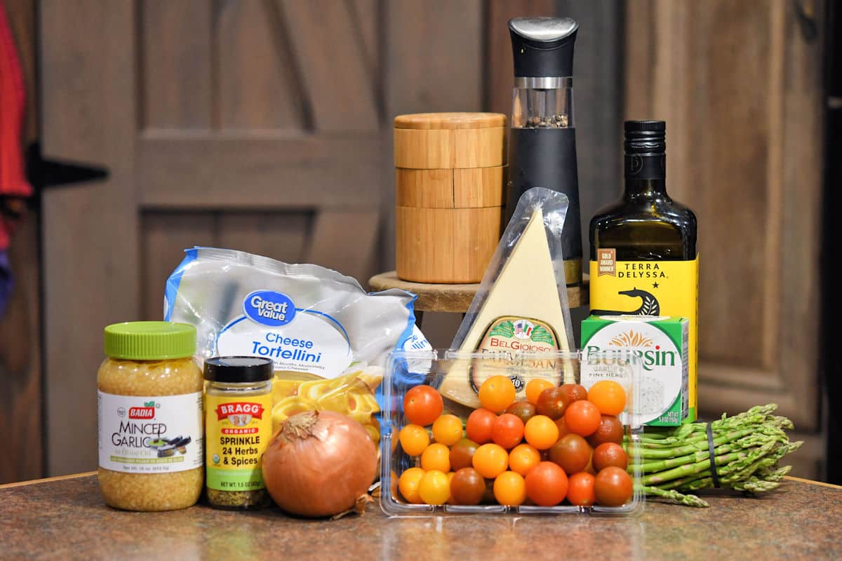 ingredients for Cheesy Asparagus Tortellini on a tabletop