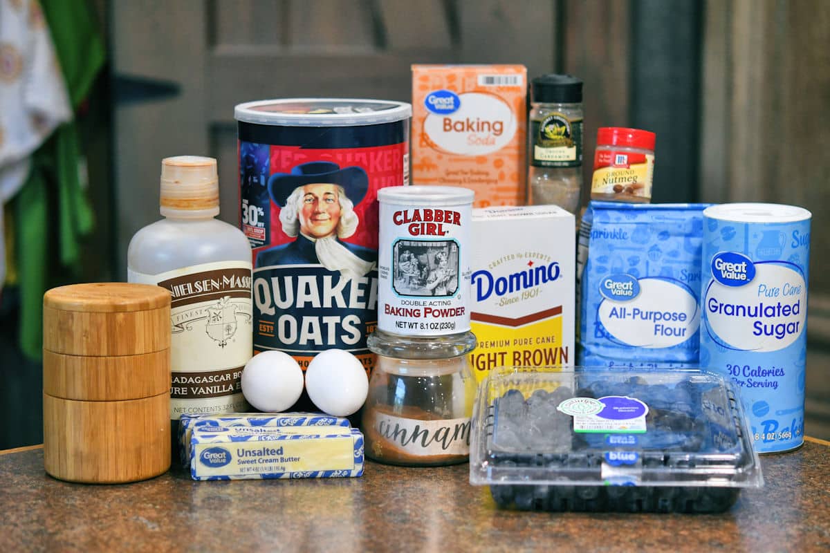 ingredients for blueberry oatmeal cookies including oats, flour, fresh blueberries and butter