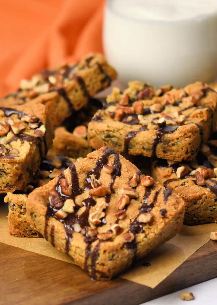 decorated chocolate chip cookie bars with a small glass of milk